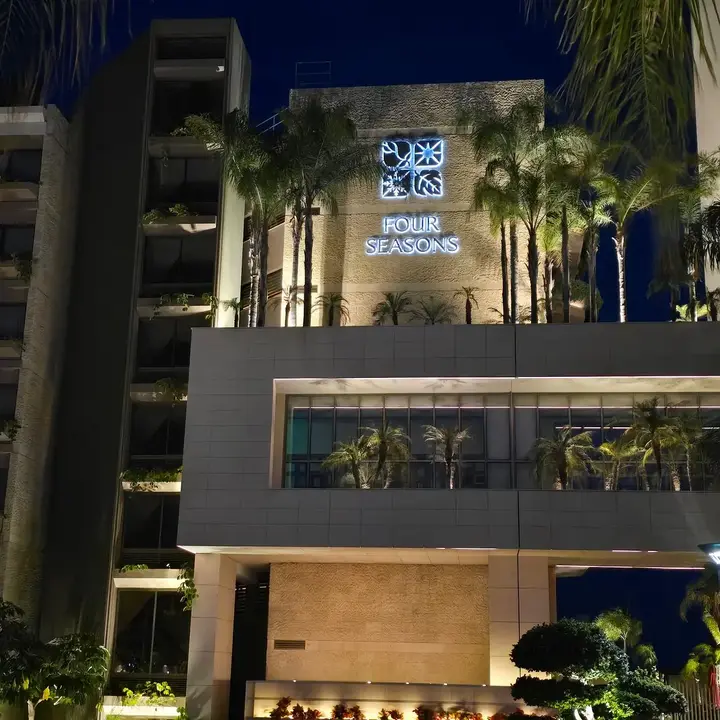 Four Seasons Hotel Limassol tower and illuminated entrance at night