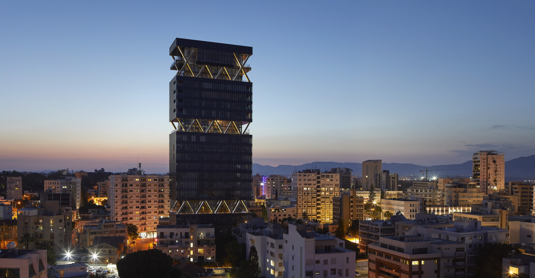 Labs Tower illuminated above the Nicosia skyline at dusk