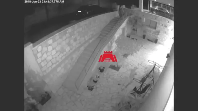 Night-vision security footage showing a person detected at the family home